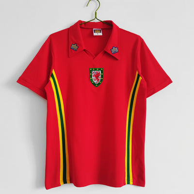 a red polo shirt with a green and yellow stripe