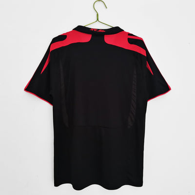 a black and red shirt hanging on a hanger