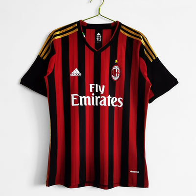 a red and black soccer jersey hanging on a hanger