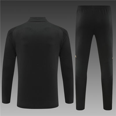 a man's black tracksuit with gold detailing