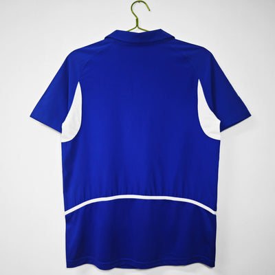 a blue shirt hanging on a white wall