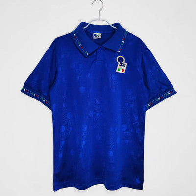 a blue polo shirt with a badge on it