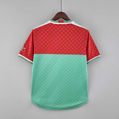 a red and green polo shirt hanging on a hanger