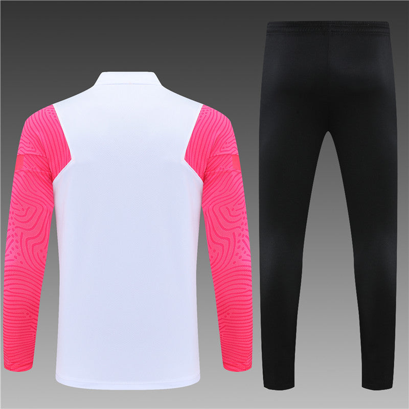 a white and pink shirt and black pants