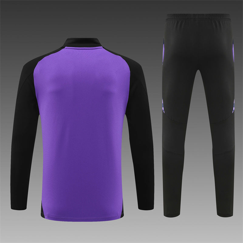 a purple and black soccer jersey and pants