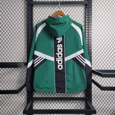 a green adidas jacket hanging on a rack