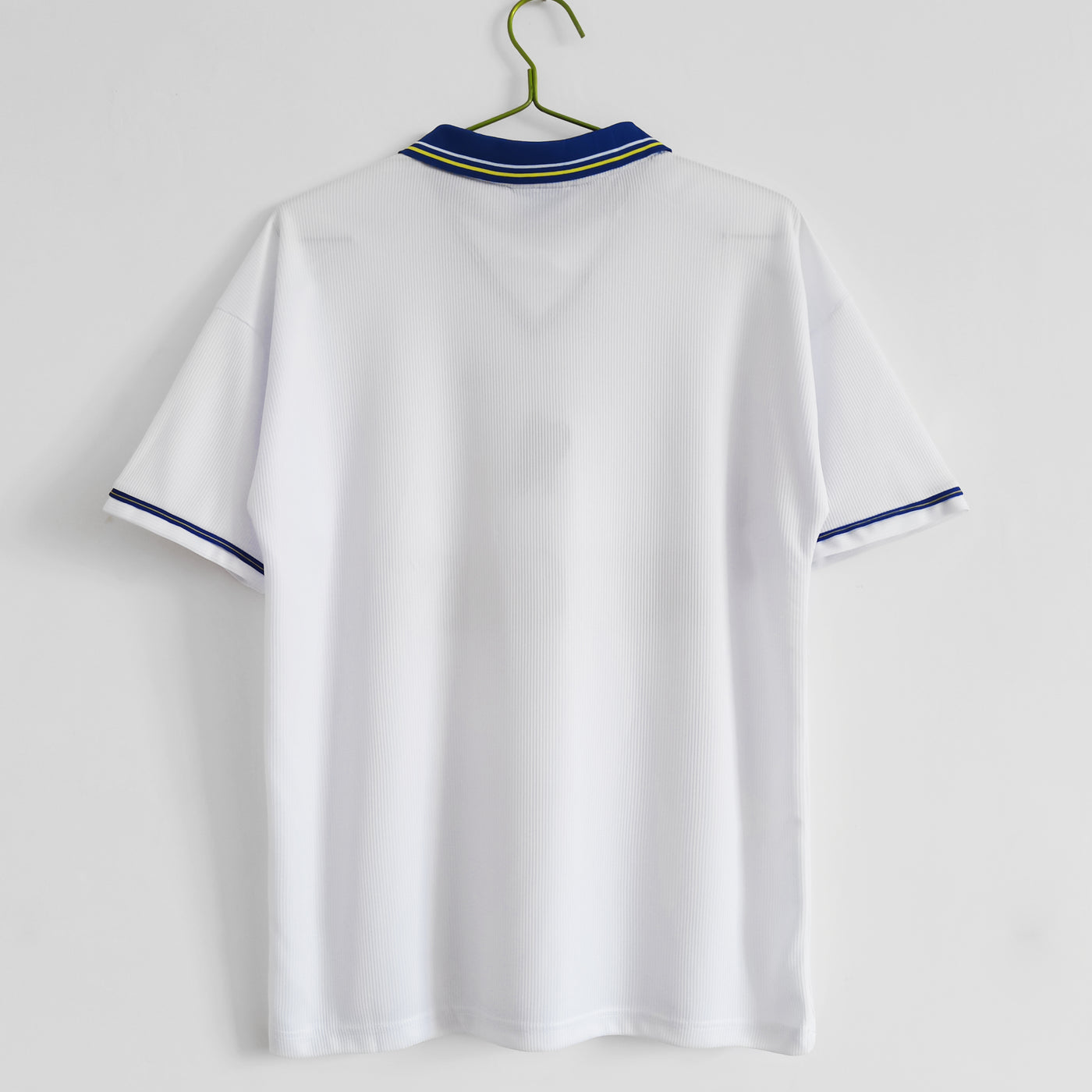 a white shirt hanging on a hanger