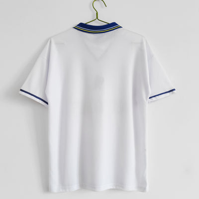 a white shirt hanging on a hanger