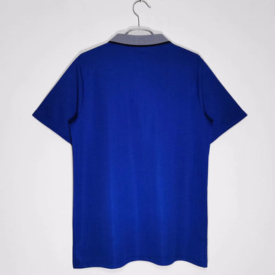 a blue t - shirt hanging on a hanger