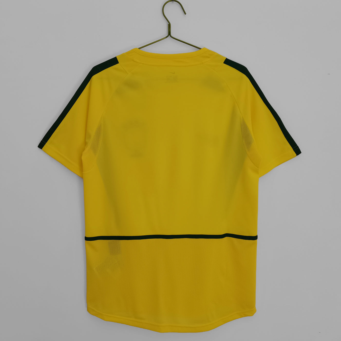 a yellow shirt hanging on a hanger