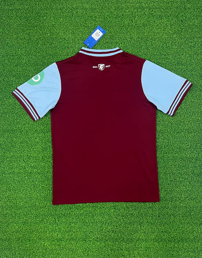 a maroon and blue shirt on a green field