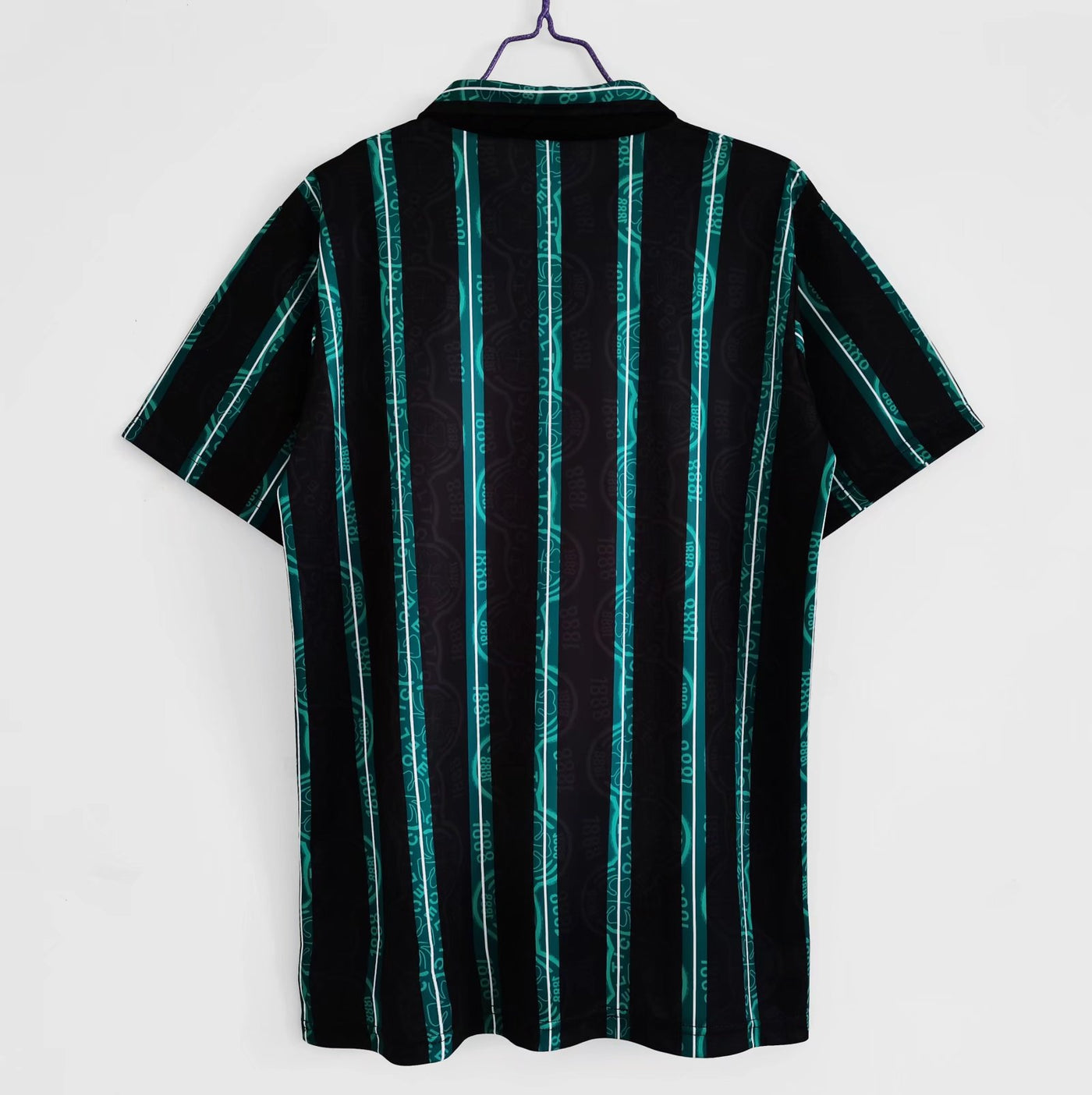 a black and green striped shirt hanging on a wall