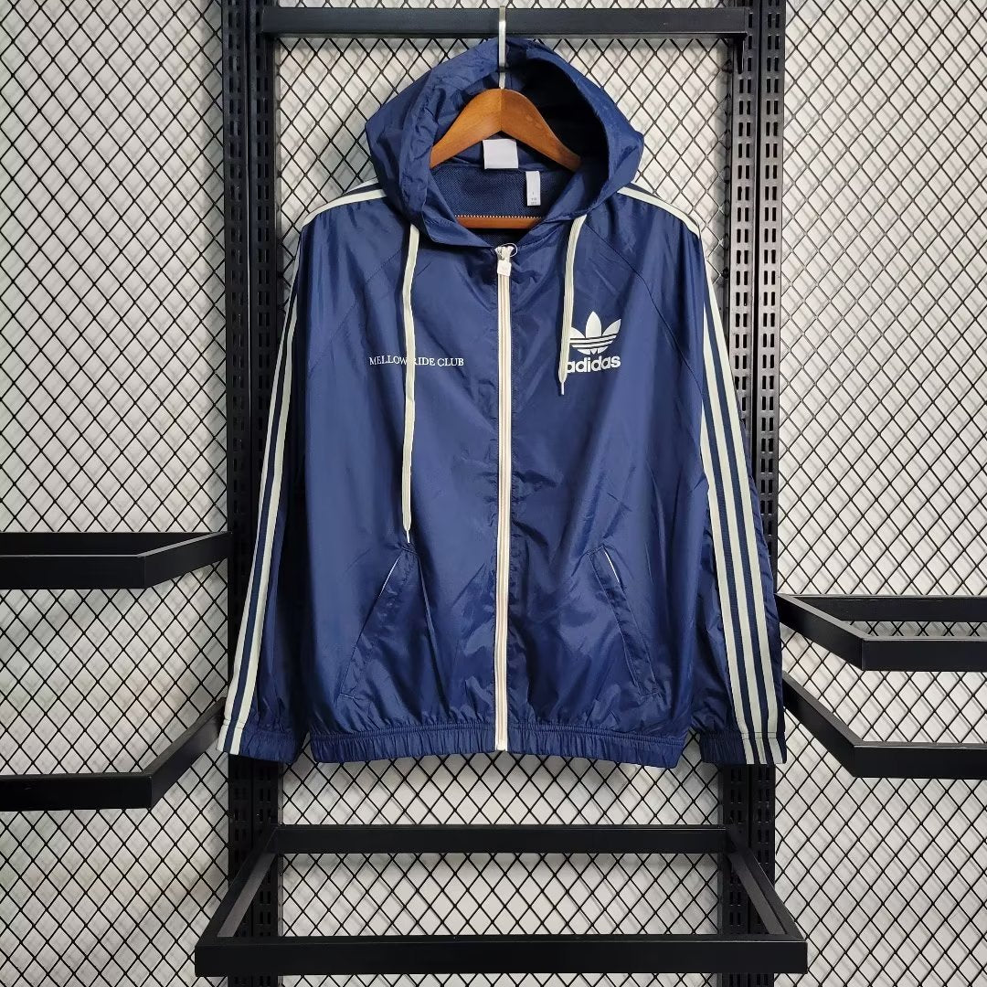 a blue adidas jacket hanging on a rack