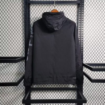 a black jacket hanging on a metal rack