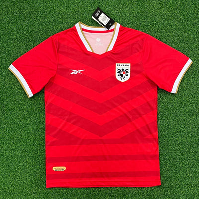 a red soccer jersey laying on a green field