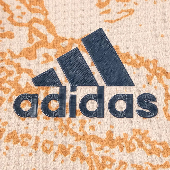 the adidas logo on a white and orange shirt