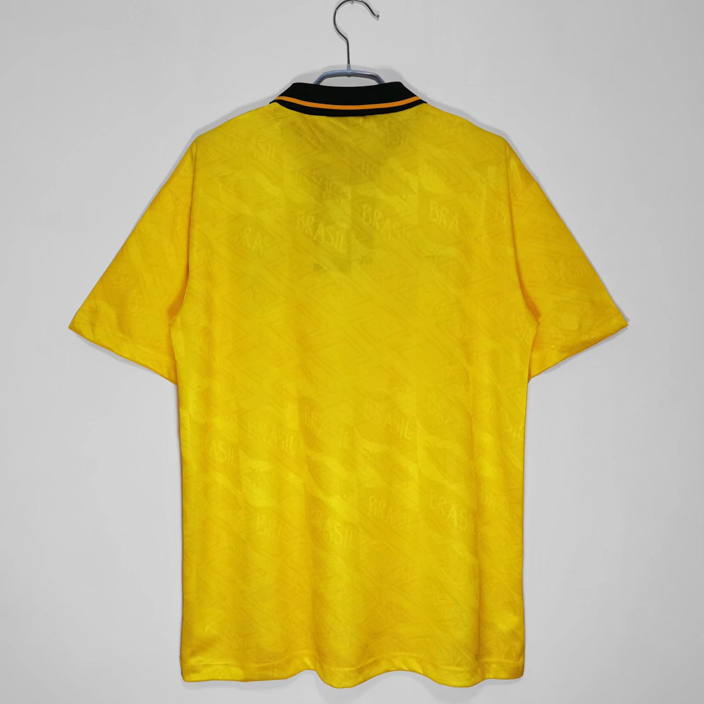 a yellow shirt hanging on a hanger