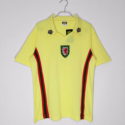 a yellow polo shirt with a green and red stripe