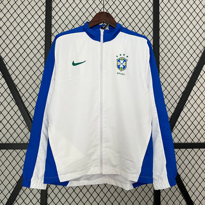 a white and blue jacket hanging on a fence