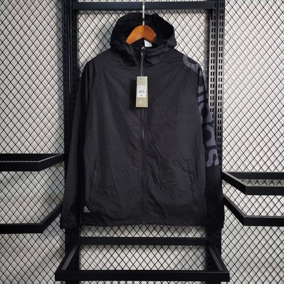 a black jacket hanging on a metal rack