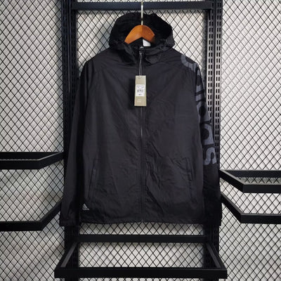 a black jacket hanging on a metal rack