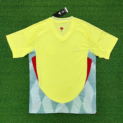 a yellow shirt laying on top of a green field