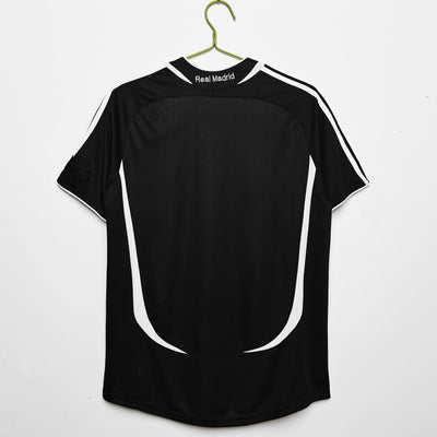 a black and white soccer jersey hanging on a hanger