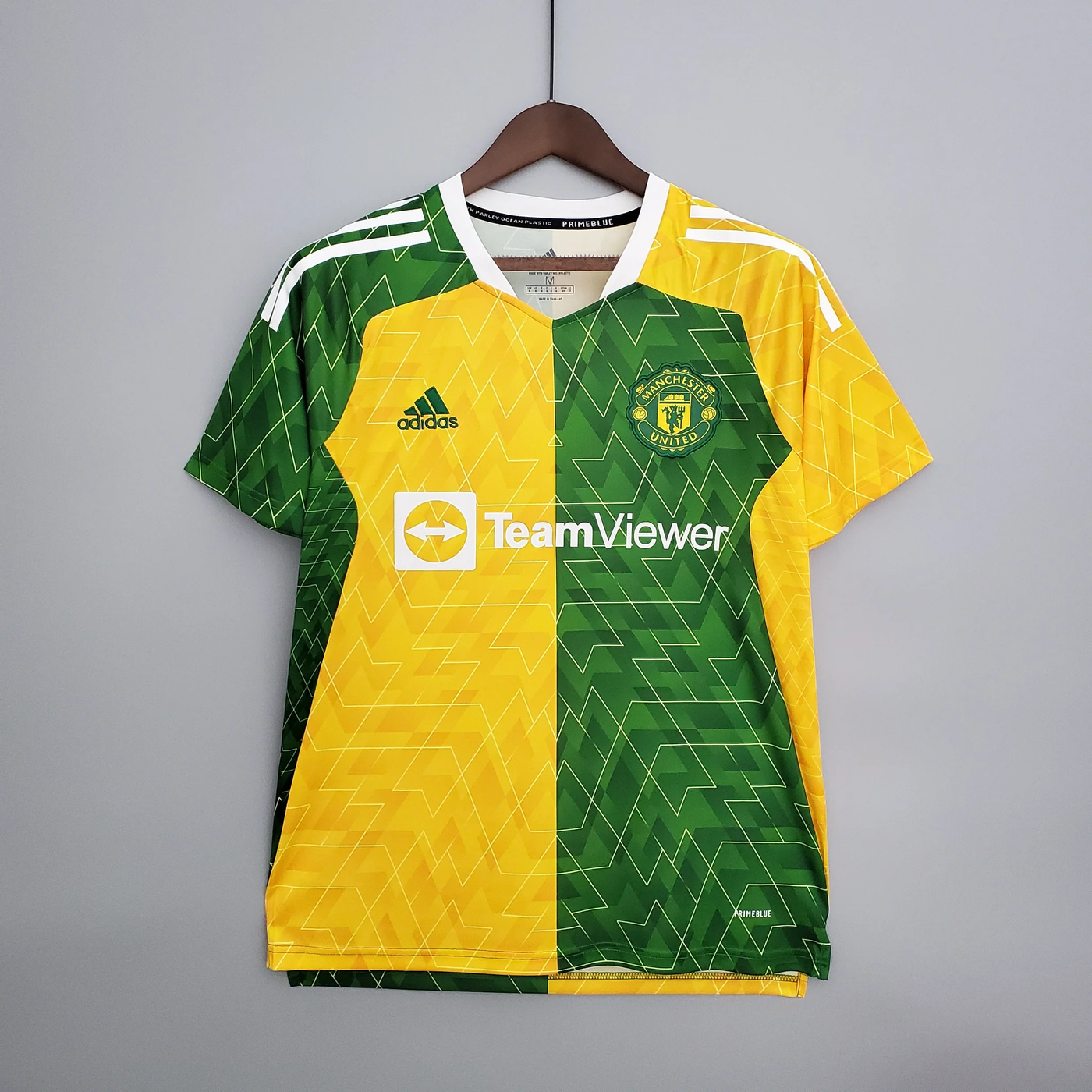 a yellow and green soccer jersey hanging on a hanger