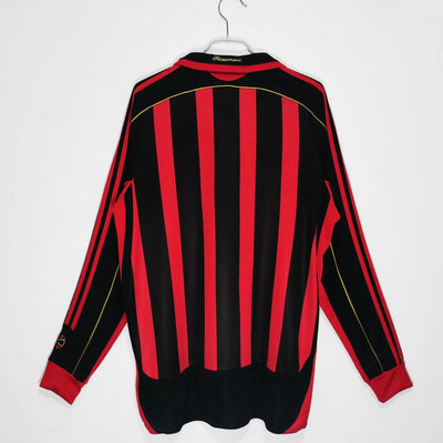 a red and black striped jacket hanging on a hanger