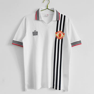 a white polo shirt with a black and red stripe around the collar