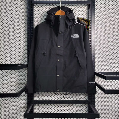 a black jacket hanging on a metal rack