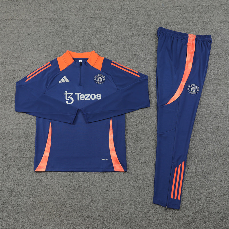 a blue and orange soccer uniform is laying on the ground