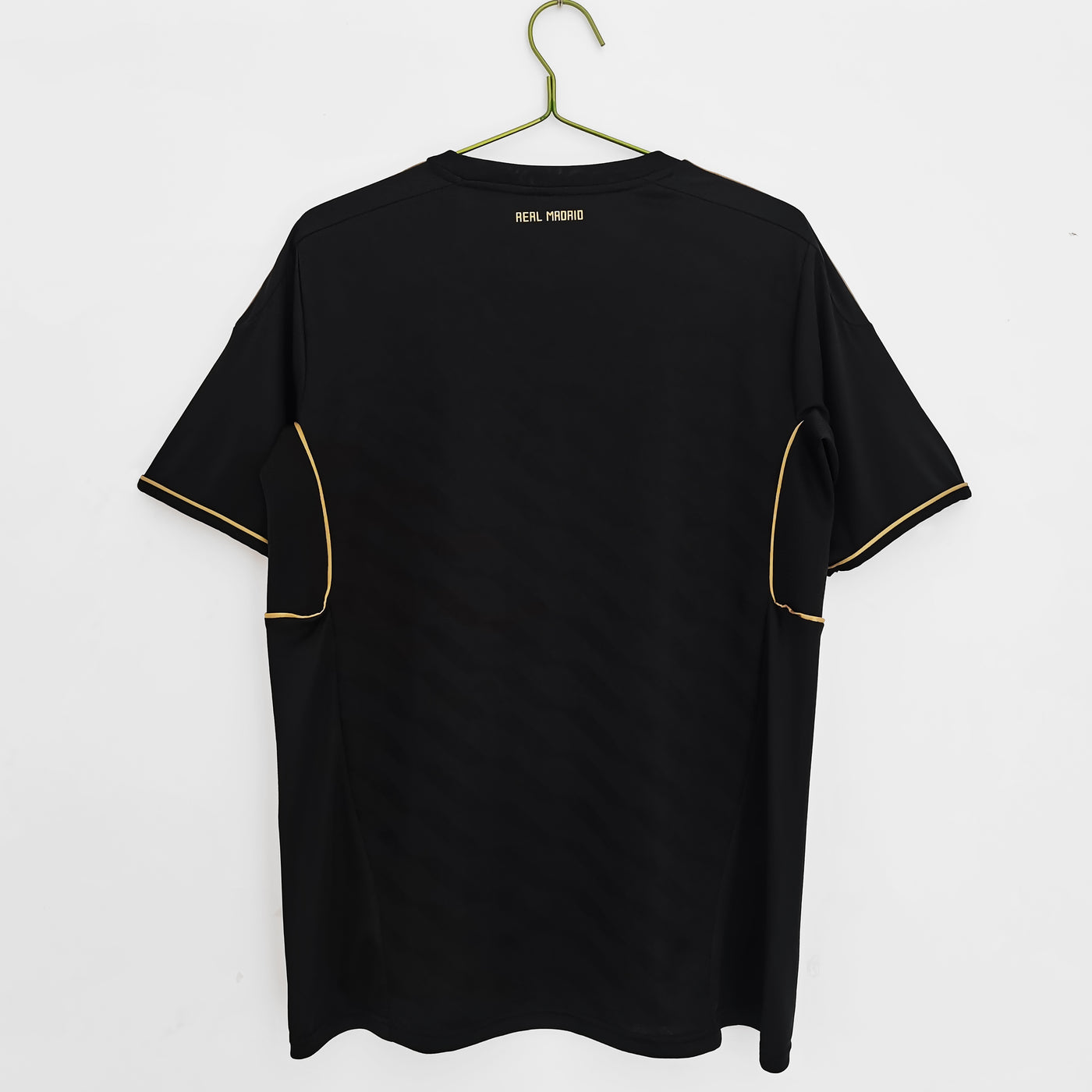 a black t - shirt hanging on a hanger