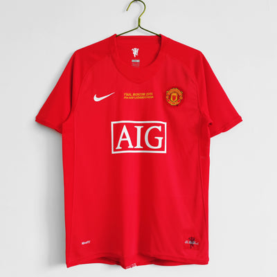 a red shirt hanging on a hanger