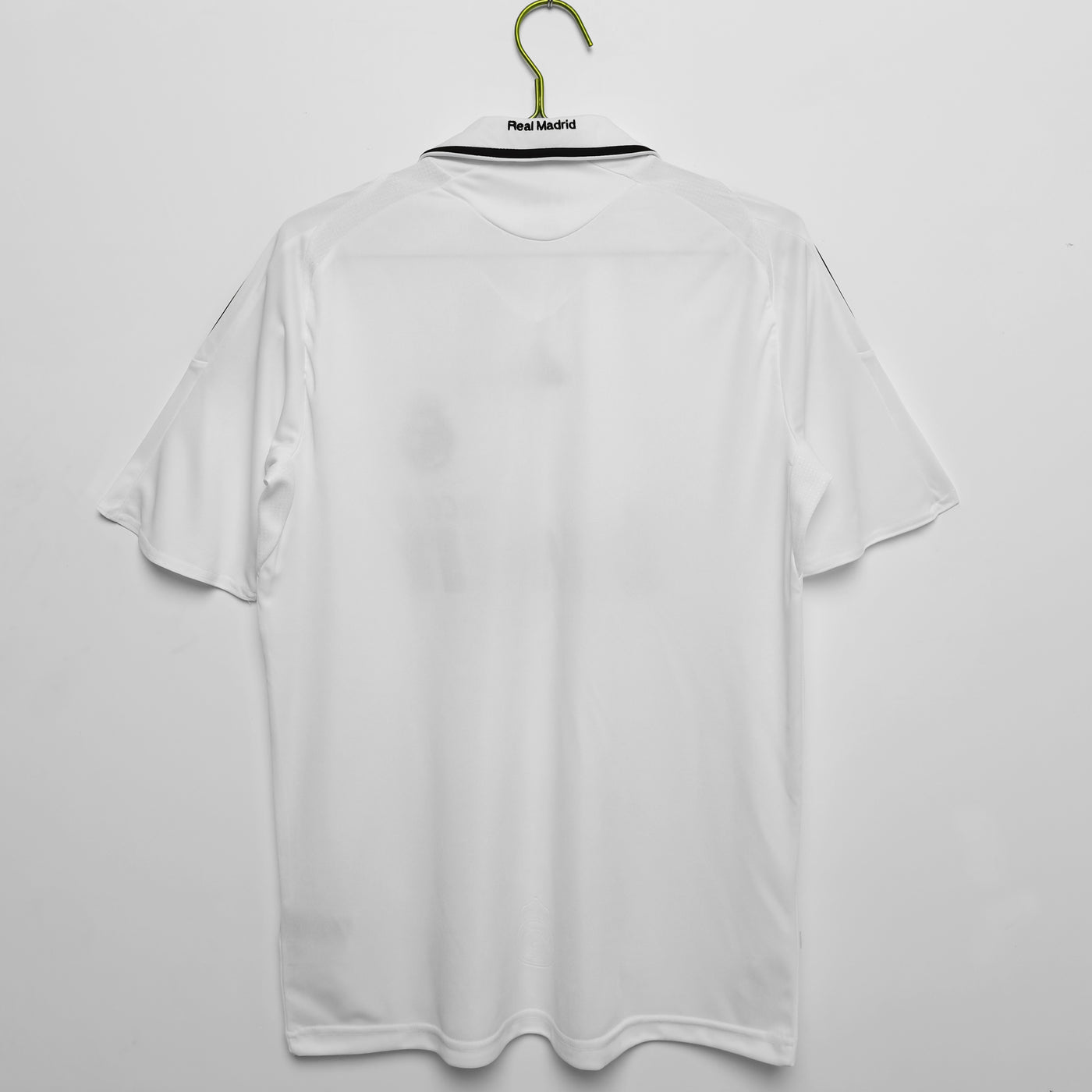 a white shirt hanging on a hanger