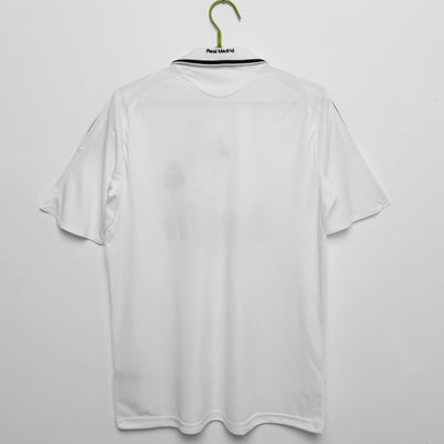 a white shirt hanging on a hanger