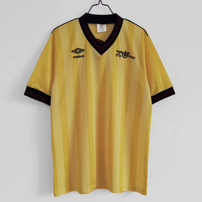 a yellow and black shirt hanging on a wall