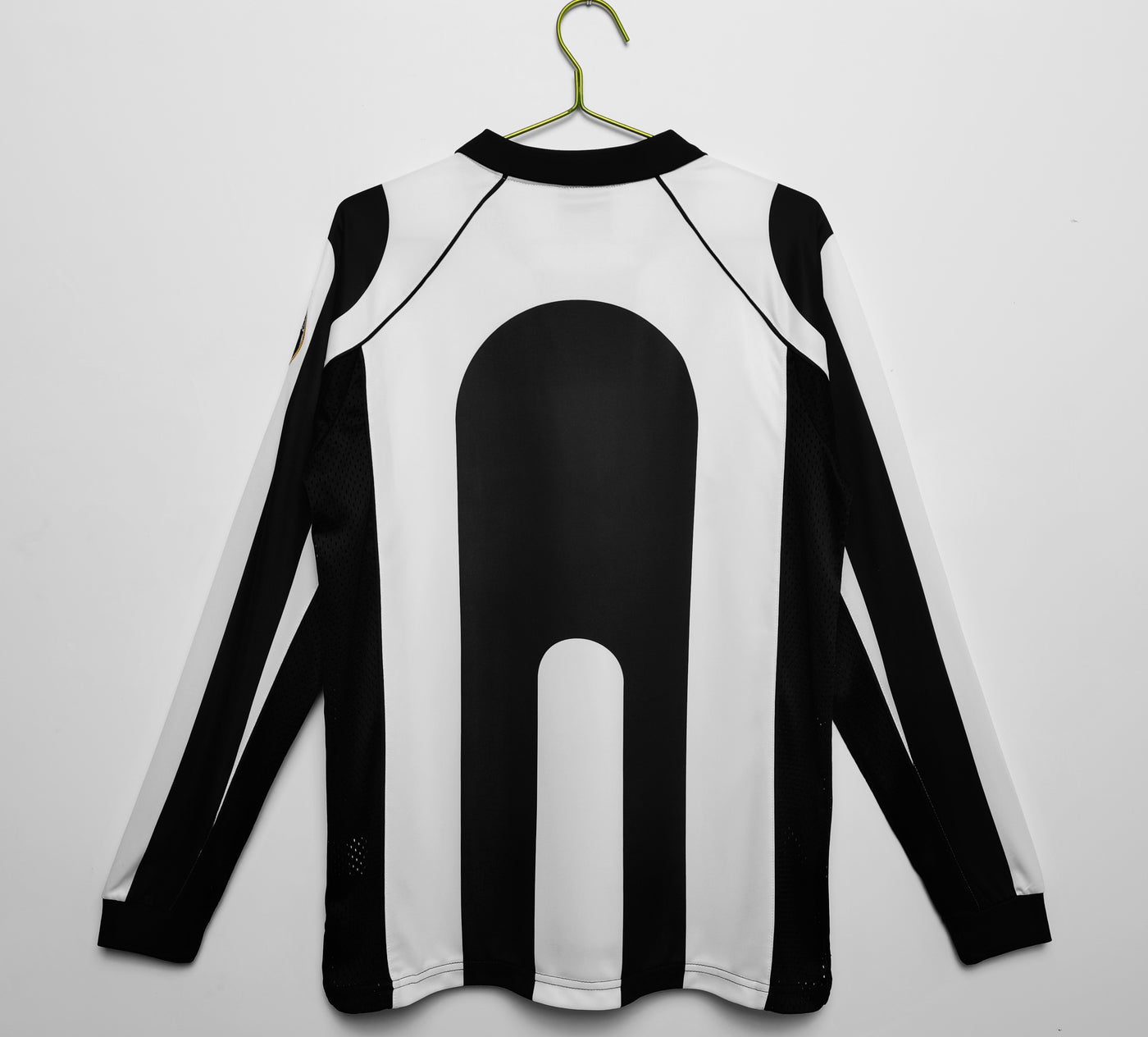 a black and white shirt hanging on a hanger