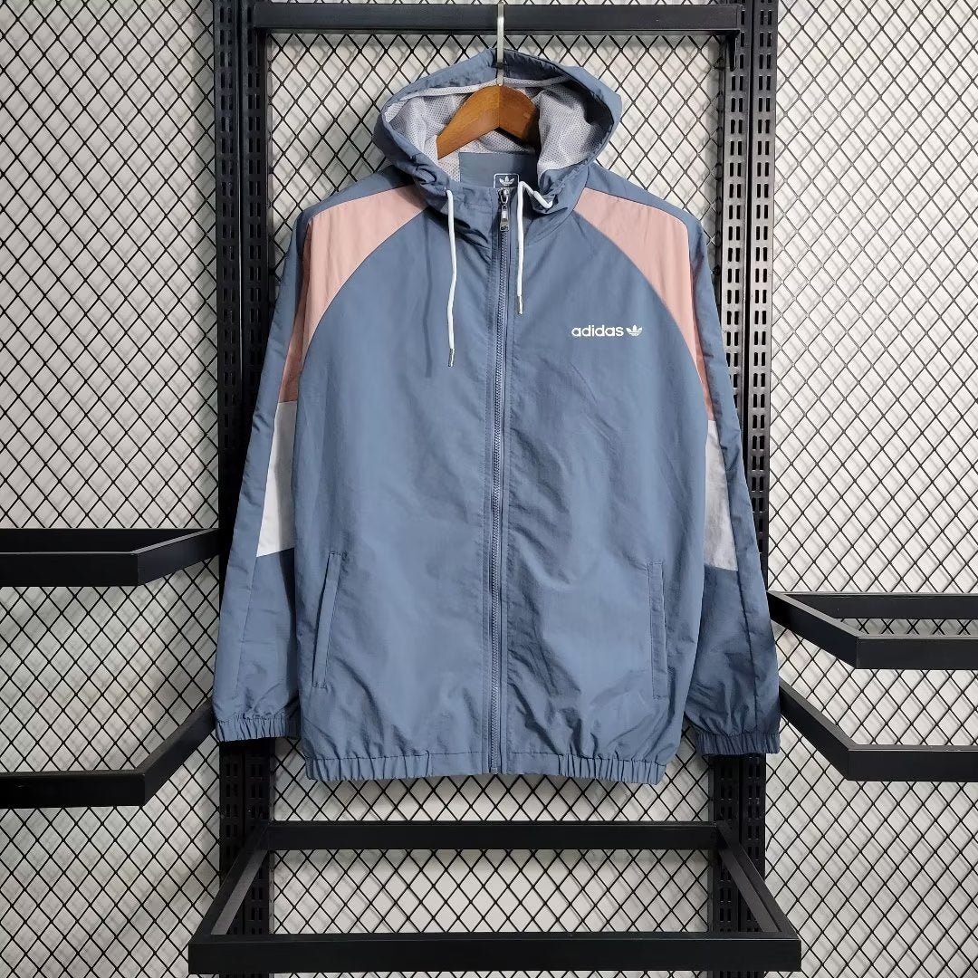 a blue and pink jacket hanging on a rack