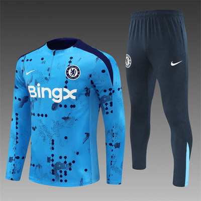 a blue and black soccer uniform and pants