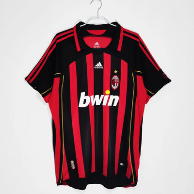 a red and black soccer jersey hanging on a hanger